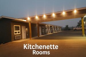 a night view of a kitzhaber room with lights at Centennial Motel in Kindersley