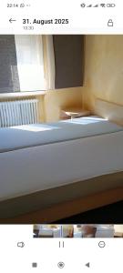 a room with two beds and a window at Golden Rangau Hotel & Pension in Langenzenn