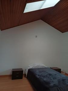 a bedroom with a bed and a skylight at CASA BOUTIQUE Villa del Prado in Bogotá