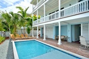 a house with a swimming pool in front of a house at Mother Ocean in Key West