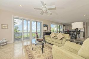 a living room with a couch and a ceiling fan at Mother Ocean in Key West