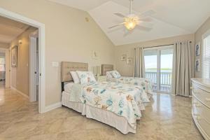 a bedroom with two beds and a ceiling fan at Mother Ocean in Key West +46 photos