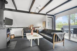 a living room with a couch and a table at C11204-Hemmet-Bowleren-1 in Hemmet