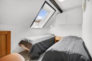 two beds in a small room with a window at C11204-Hemmet-Bowleren-1 in Hemmet