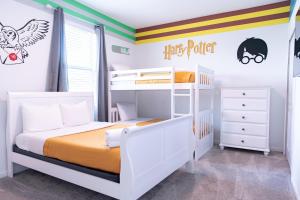 a bedroom with two bunk beds and a striped wall at Disney Magic ChampionsGate Resort House 15 min from Disney World, with Club House, 7 Pools and Water Park in Kissimmee