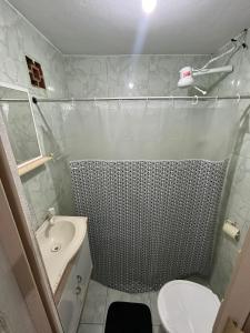 a bathroom with a shower and a sink and a toilet at Kitnet temporada mobiliada Beira Mar in Rio das Ostras