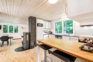 a kitchen with a wooden table and a dining room at C11252-hemmet-Anevej-7 in Hemmet +26 photos