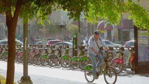 a man riding a bike in front of a row of parked bikes at céntrico guadalajara in Guadalajara