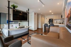a bedroom with a bed and a living room at La Mar by Geko in Lima