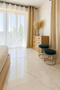 a bedroom with two chairs and a bed and a dresser at Garda Lake Holiday Apartments Trilocale in Cavalcaselle