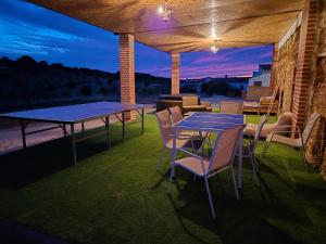 a patio with two ping pong tables and chairs at Monte do Moinho Vento in Casas Novas de Marés