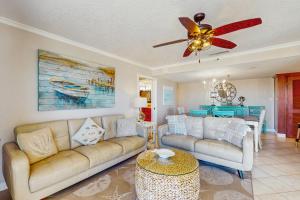 a living room with a couch and a ceiling fan at Anglers Cove 608 in St. Pete Beach