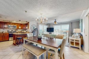 a kitchen and dining room with a table and chairs at Anglers Cove 608 in St. Pete Beach