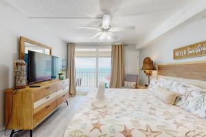 a bedroom with a flat screen tv and a bed at Sand Castle II 2801 in Clearwater Beach