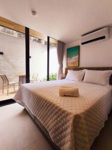 Ένα ή περισσότερα κρεβάτια σε δωμάτιο στο Flats térreo pé na areia no Alta Marine