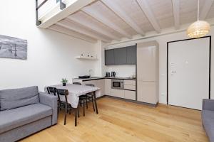 a living room with a table and a couch at BG Suite in Bergamo