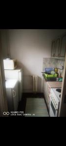 a small kitchen with a sink and a stove at Apartman Dunja in Belgrade