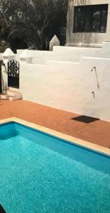 a swimming pool in front of a house at Casa Vento in La Asomada