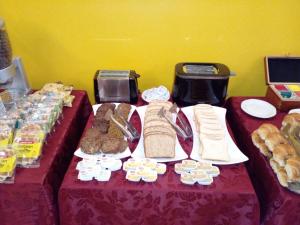 a table with a bunch of bread and pastries on it at Hotel Tres Sargentos in Buenos Aires +22 photos