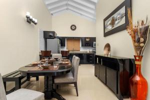 a kitchen and dining room with a table and chairs at Cozy Cove Villa in Drax Hall in Saint Annʼs Bay