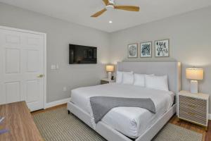 une chambre blanche avec un lit et un ventilateur de plafond dans l'établissement The Sabal 3BR 3BA with Hot Tub, à Columbia