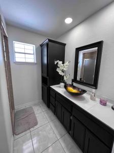 a bathroom with a sink and a mirror at Luxury Home 3bdroom- 2bath in Donna
