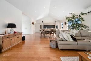 a living room with a couch and a kitchen at Katelyn Hideaway in Kinloch