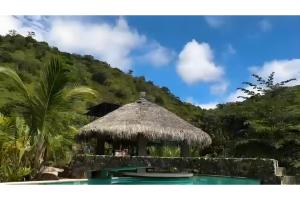 a resort with a swimming pool and a hut at Nature Escape Villa with Pools and Jacuzzis and Pet-Friendly Stay in Puerto López