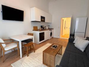 a living room with a couch and a table and a kitchen at Best Spot in XBerg in Berlin +5 photos