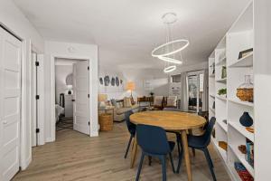 a dining room and living room with a table and chairs at Fully updated condo ski in ski out hot tub pool in Lutsen