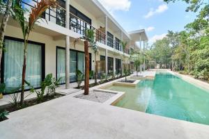 an exterior view of a house with a swimming pool at BT Homes - Wellness Jungle in Tulum