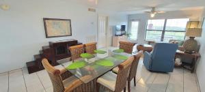 a dining room with a glass table and chairs at Saida Towers II #104 condo in South Padre Island
