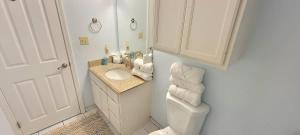 a white bathroom with a sink and a toilet at Saida Towers II #104 condo in South Padre Island +106 photos