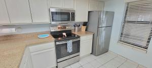 a kitchen with a stove and a refrigerator at Saida Towers II #104 condo in South Padre Island