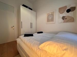 a bedroom with two beds and a white cabinet at Best Spot in XBerg in Berlin