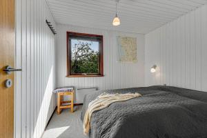 a bedroom with a bed and a window at C11603-Norre-Nebel-Marskvej-24 in Nørre Nebel