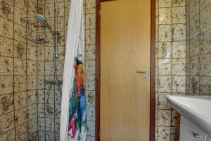 a bathroom with a shower with a towel on the door at C11603-Norre-Nebel-Marskvej-24 in Nørre Nebel +30 photos