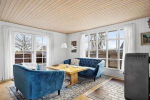 a living room with blue chairs and a wooden table at SJ243-Haderslev-Vikaerparken-79 in Haderslev