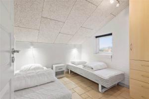 a bedroom with two beds and a window at C11316-Tarm-Stikkelsbaervej-8 in Tarm