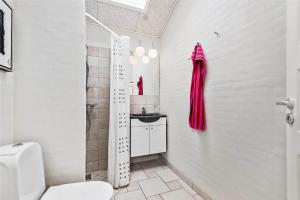 a bathroom with a toilet and a sink at C11316-Tarm-Stikkelsbaervej-8 in Tarm +29 photos