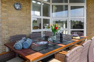 a dining room table with chairs and a brick wall at C11316-Tarm-Stikkelsbaervej-8 in Tarm
