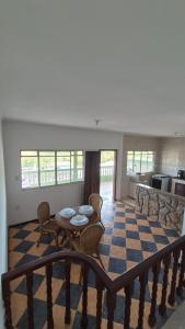 a living room with a table and chairs at Suíte319 in São José dos Campos +2 photos