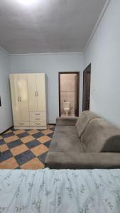 a large bedroom with a large bed and a toilet at Suíte319 in São José dos Campos