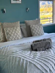 a bed with two towels on top of it at Glacier Lake House in Tatare