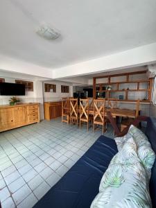 a living room with a couch and a table and a kitchen at Casa Porto do Amor in Porto De Galinhas
