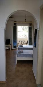 a bedroom with a bed and a table in a room at Thaleia Studios & Apartments in Kavos