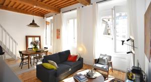 a living room with a couch and a table at Appart' Sainte Clotilde in Lyon