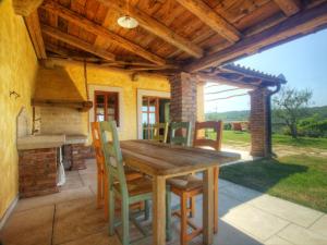 a wooden table and chairs on a patio at Dobrinja Residence Villas Lopar in Marezige