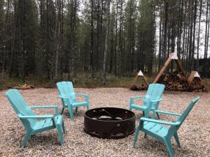 a group of chairs around a fire pit at The Alpine Cabin in Valemount