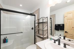 a bathroom with a shower and a toilet and a sink at The Alpine Cabin in Valemount +15 photos